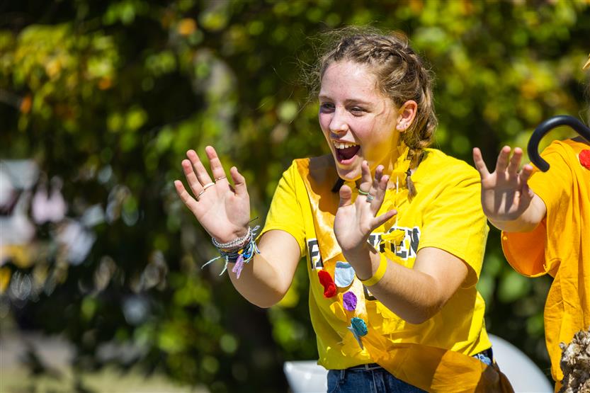 Students ride on a homecoming parade float